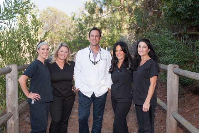 Dr. Rich and staff standing in the outdoors all work together to provide the best cosmetic dentistry services to create beautiful smiles. 