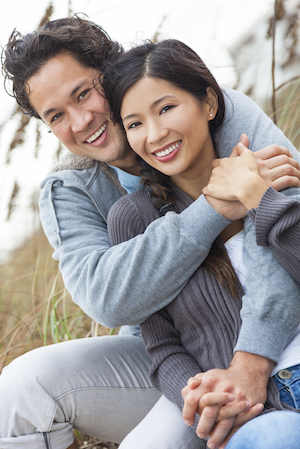 man smiling with his wife after having a dental crown put in