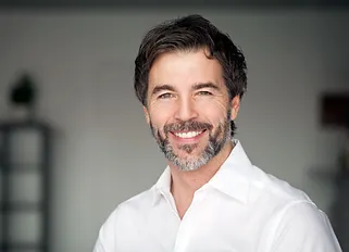 man smiling after getting 3-on-6 dental implants from Poway Dental Arts